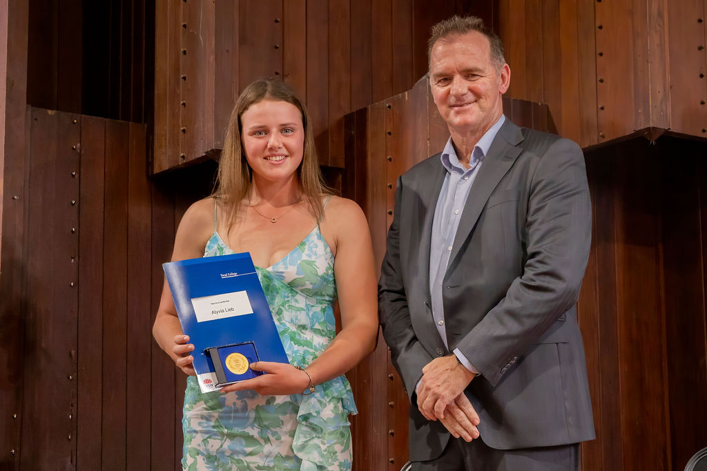 Young female graduate receiving certificate