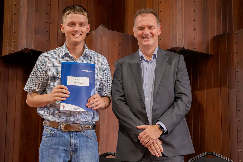 Young male graduate receiving certificate
