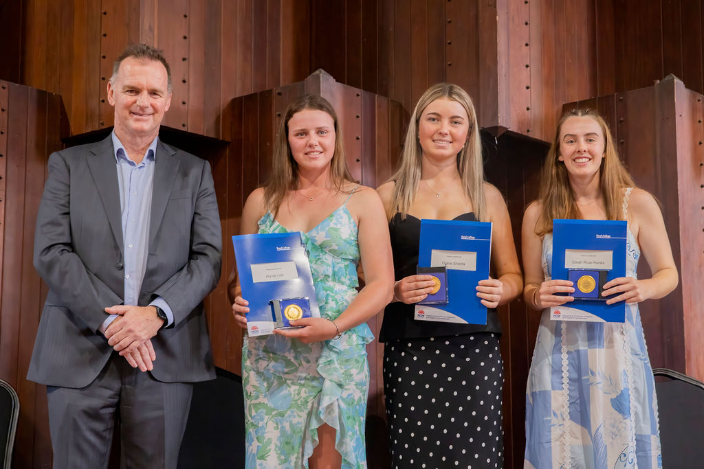 Steve Orr and 3 female graduates with certificates and Dux medals