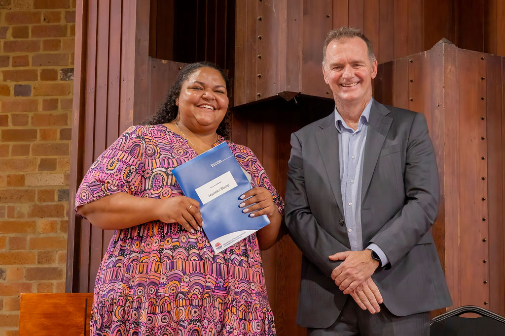 Aboriginal woman graduate receiving diploma
